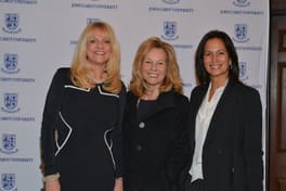 Margo Catsimatidis with two guests at the John Cabot University backdrop