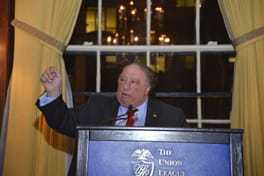 John Catsimatidis at the lectern, one arm raised