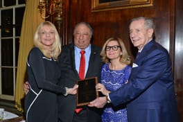 John and Margo Catsimatidis with a plaque, beside an older man and a woman in glasses